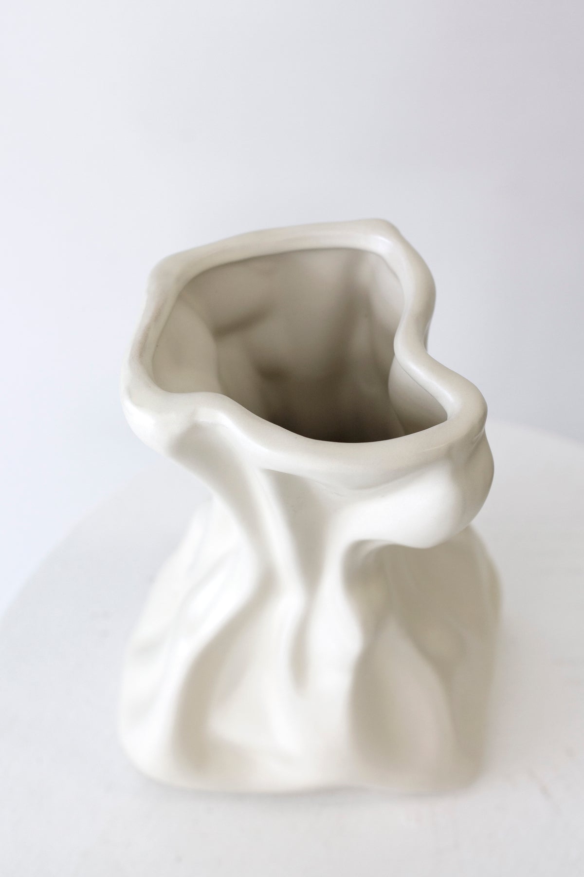Cream crinkle vase seen from above at an angle, showing the crumpled opening