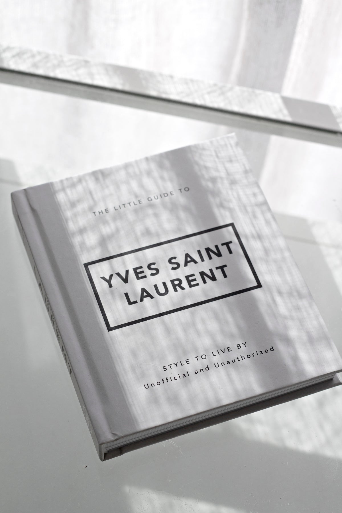 Little Guide to Yves Saint Laurent styled with home decor accessories
