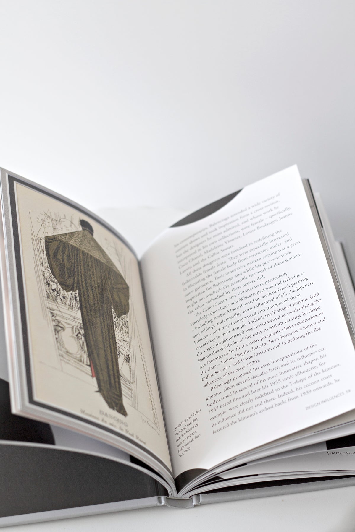 Little Book of Balenciaga styled on a marble table with a candle