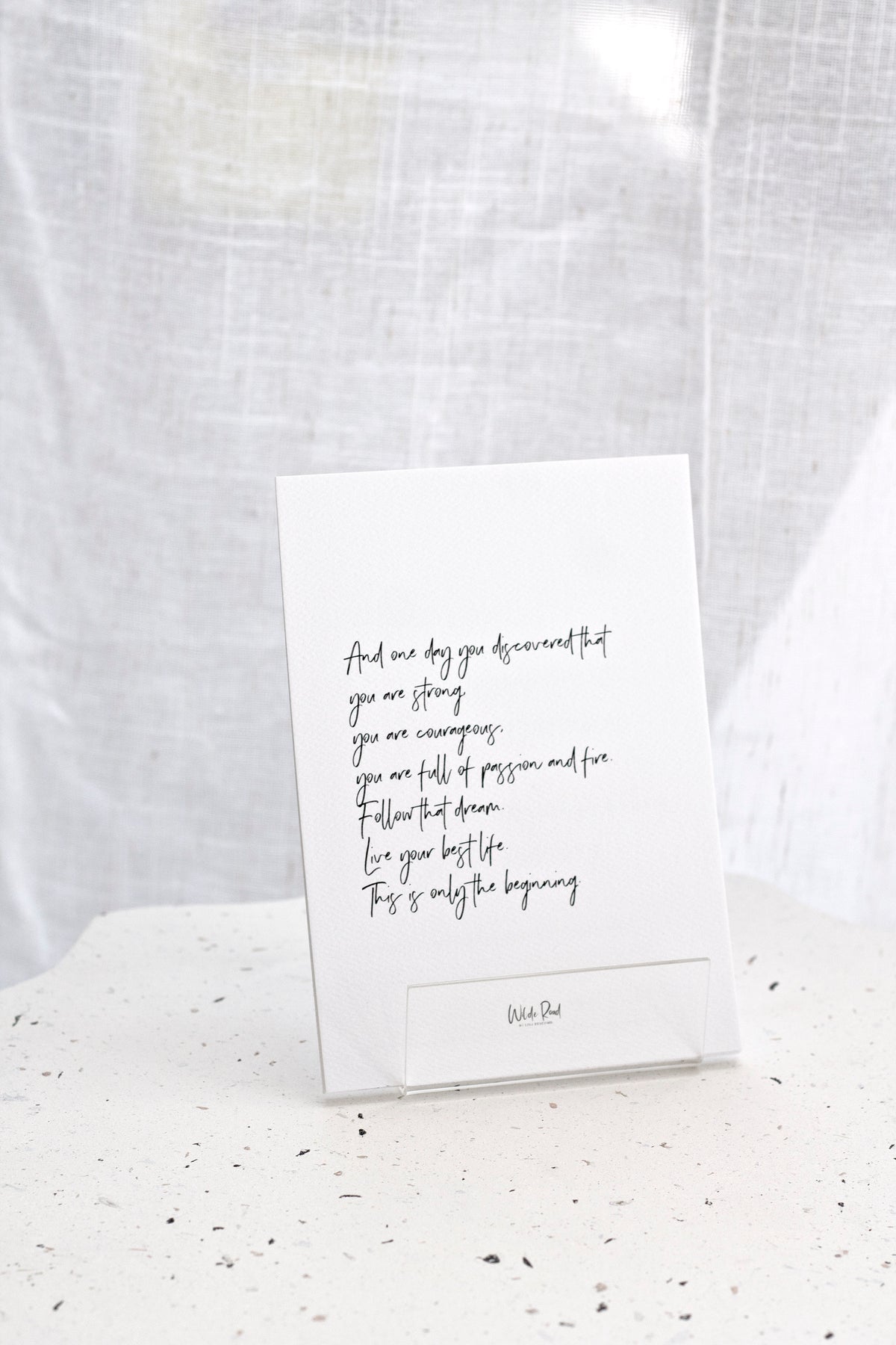 Affirmation card resting against a linen backdrop