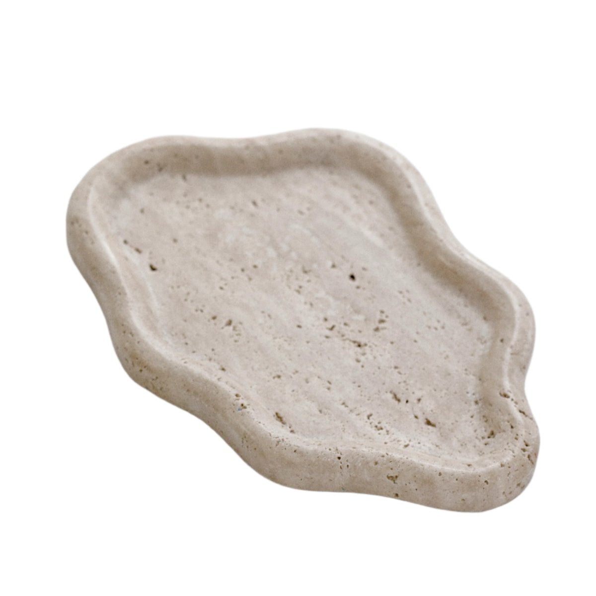 Organic travertine catchall tray, a freeform stone dish with a softly waved rim