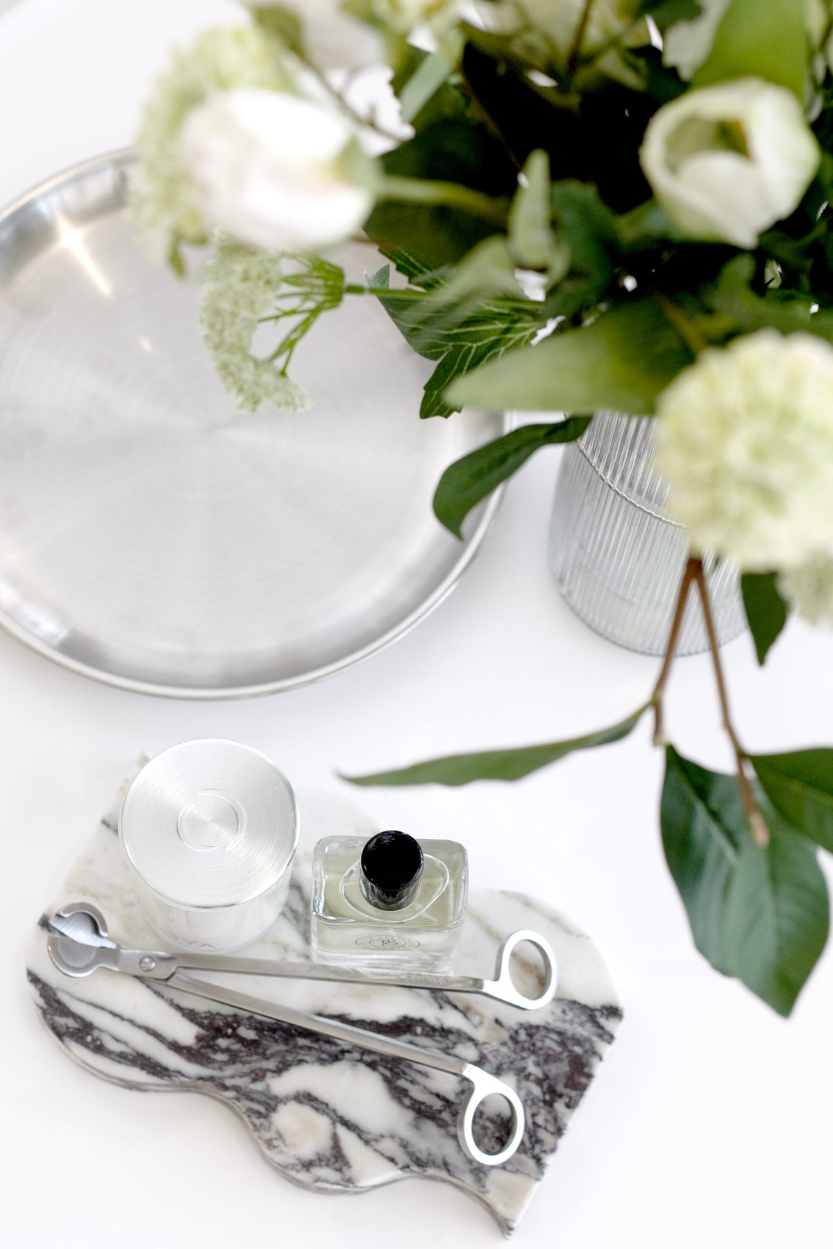 Round Stainless Steel Decor Tray styled on a bathroom vanity