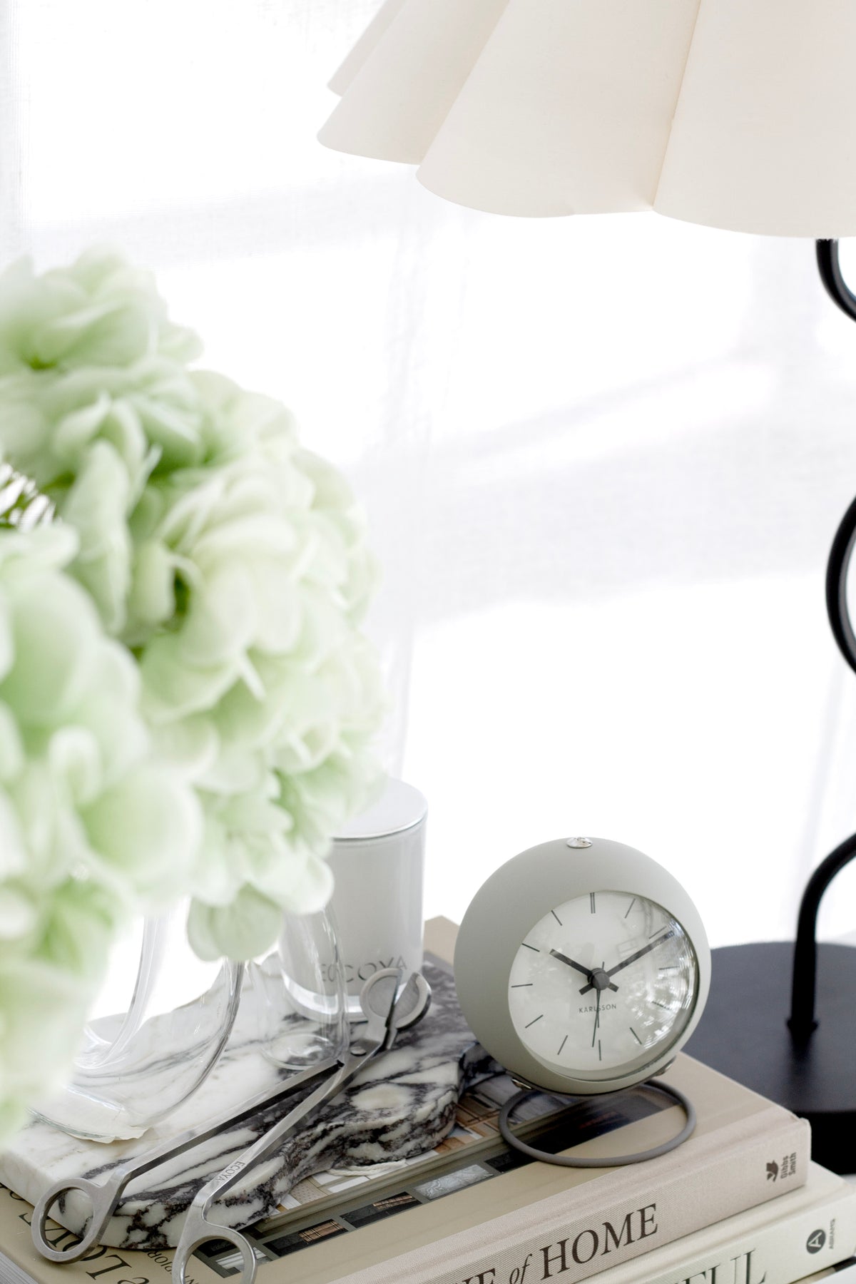 Karlsson Nirvana Globe Alarm Clock styled on a bedside surface