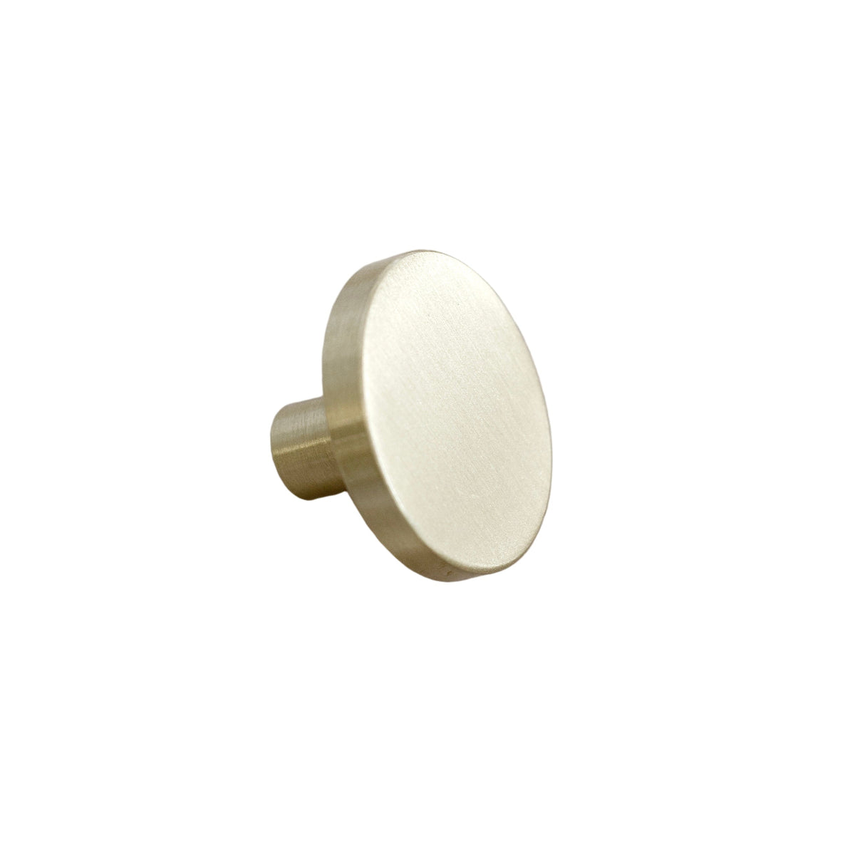 Brushed gold brass wall hook with a round face on a white background