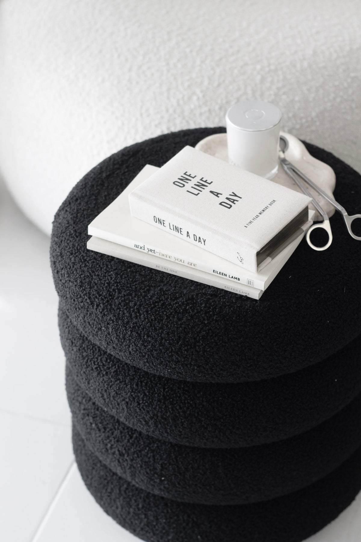 Canvas One Line a Day journal on a round black boucle ottoman
