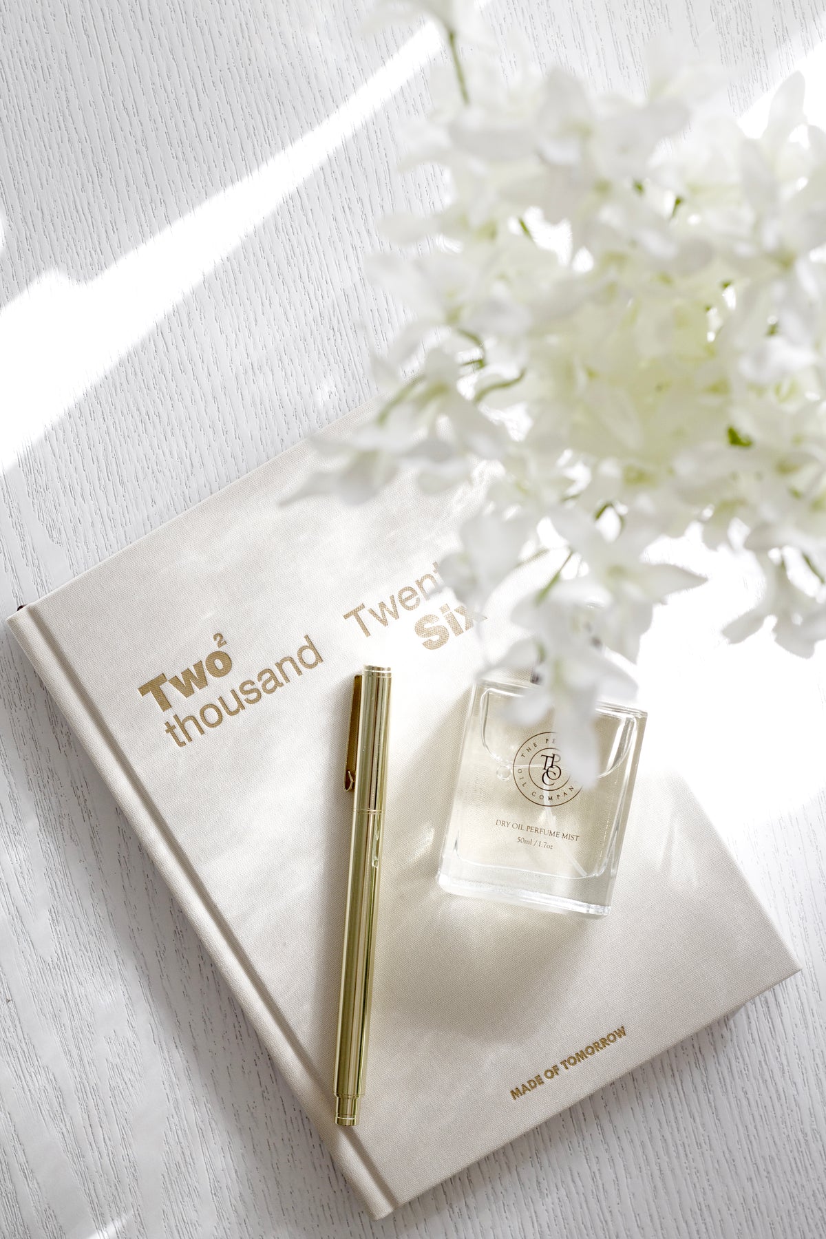 Metal Rollerball Pen Golden styled on desk with notebook by Emma Kate Co