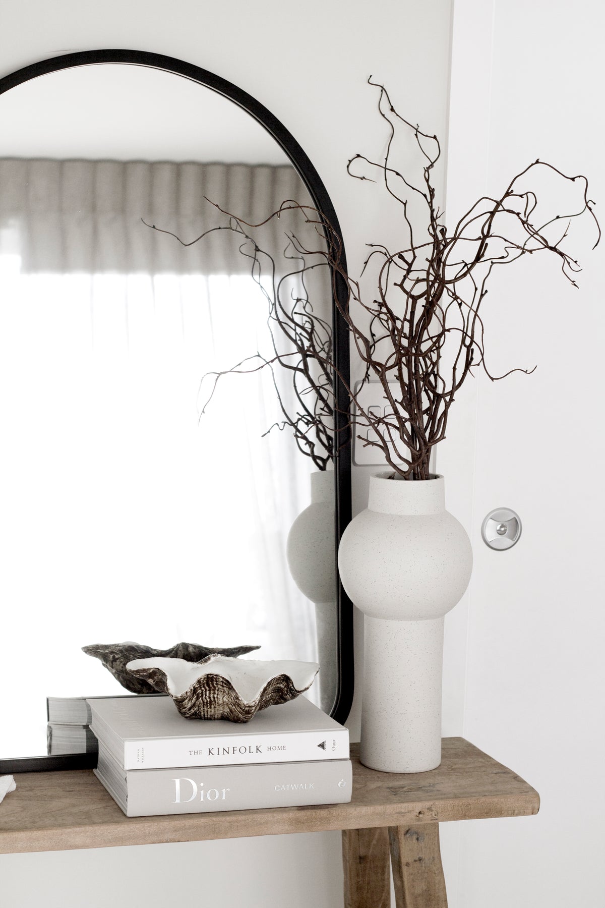 Dior Catwalk book styled on a shelf with home decor