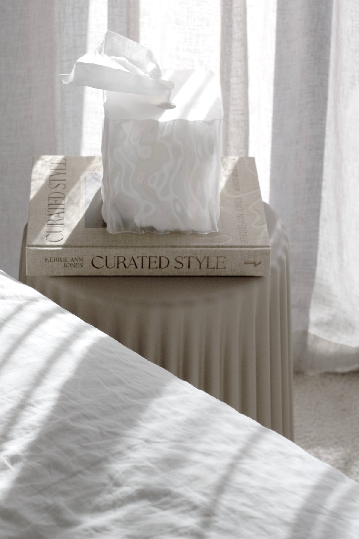 White Flow cover on a bedside beside soft white linen