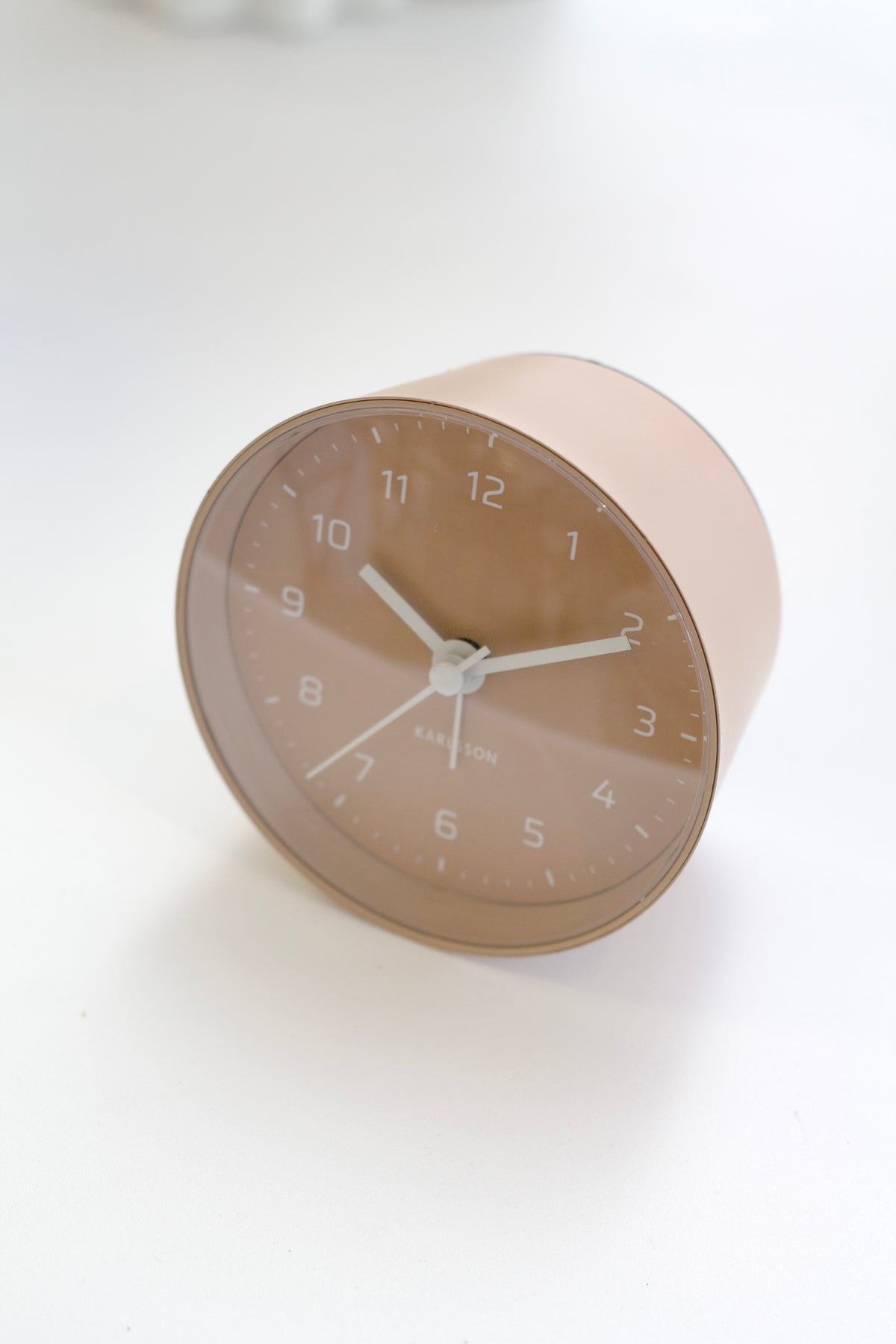 Angled view of the Sand Brown Cone alarm clock showing its tapered body