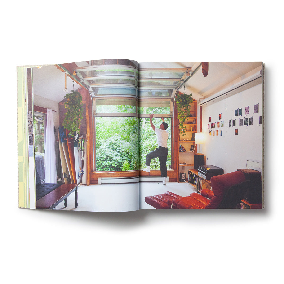 Spread of a bright living room with a hanging chair and surfboards