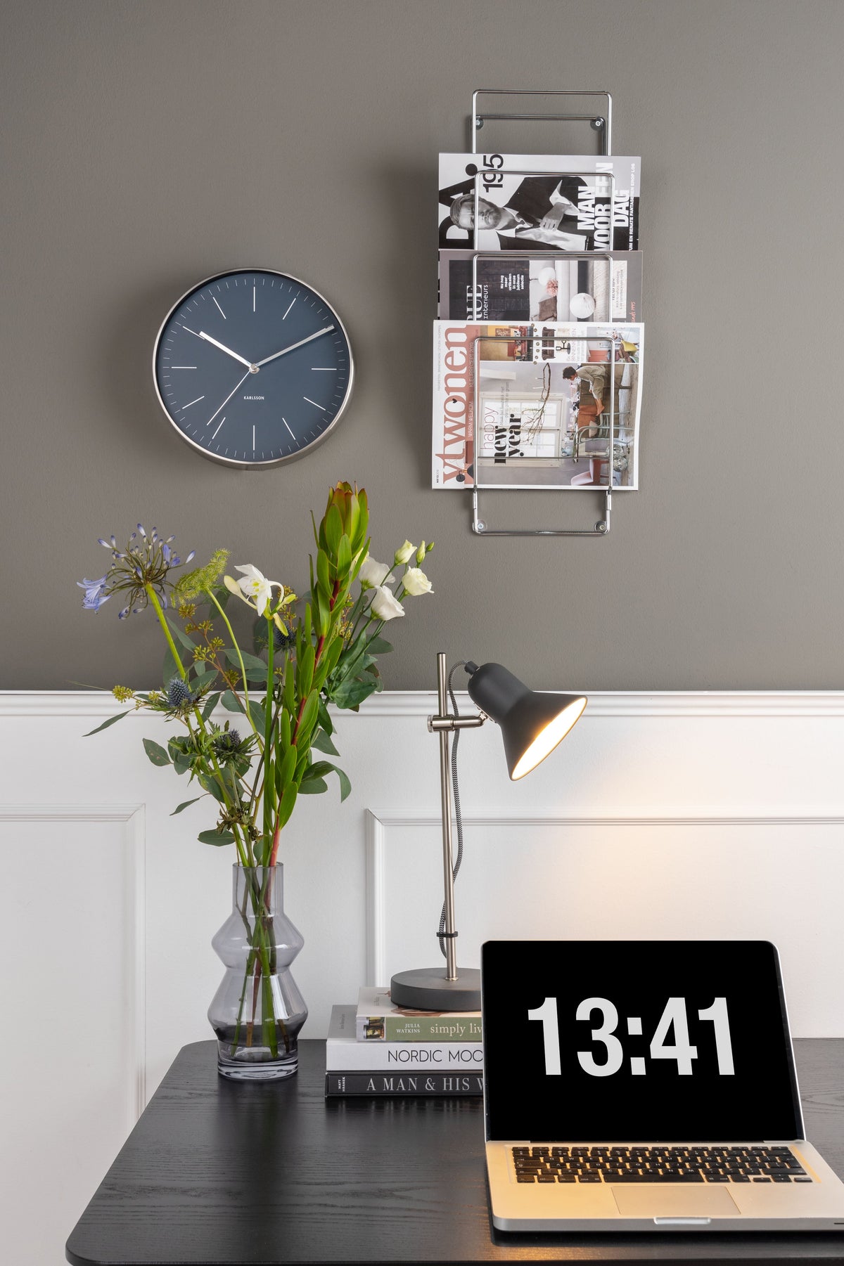 Night Blue Minimal Wall Clock on a grey wall above a desk with a laptop and a vase of flowers