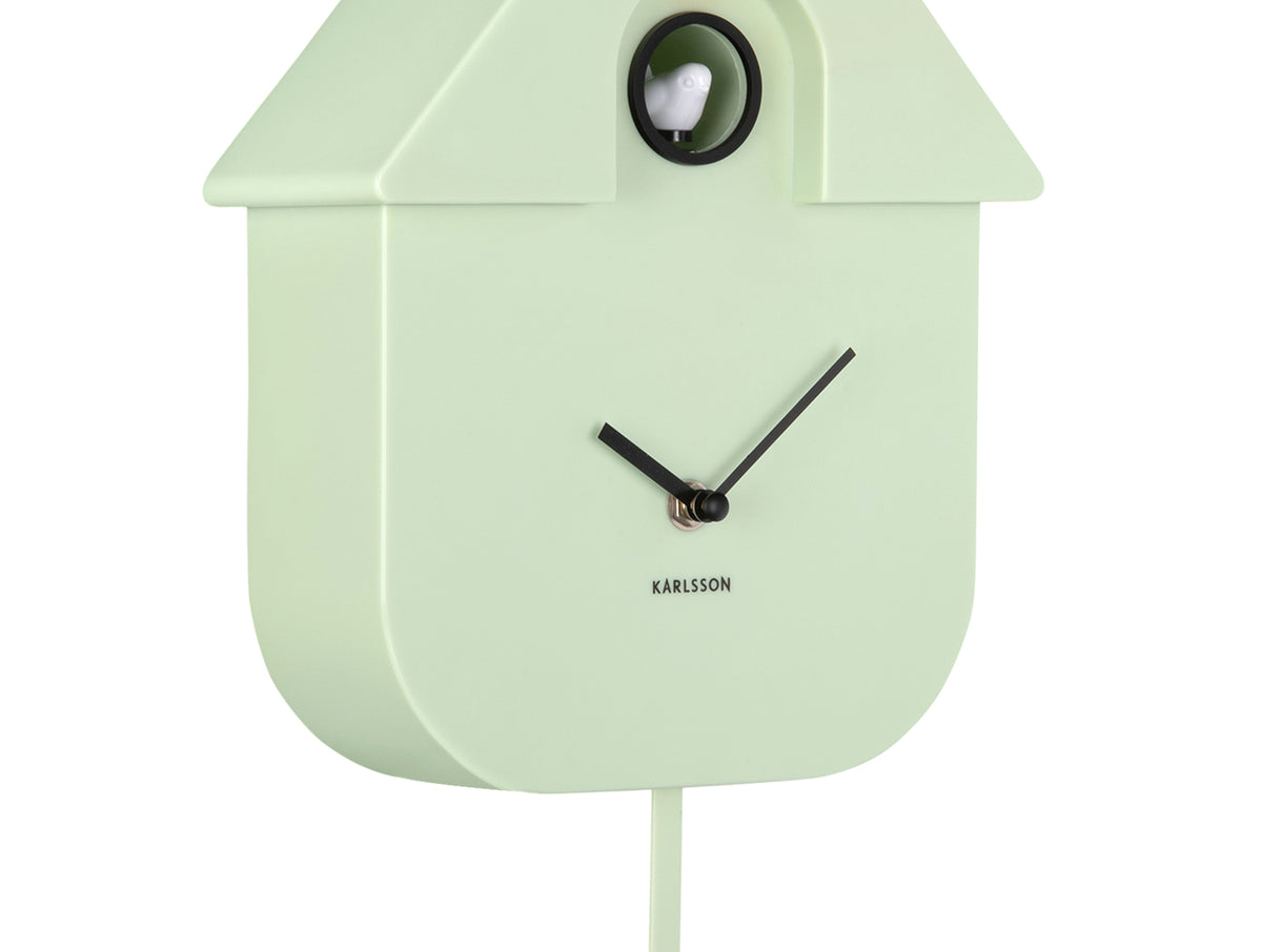Karlsson Modern Cuckoo Clock in Soft Green, angled close-up of the case and cuckoo window