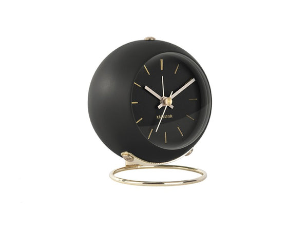 Karlsson Globe alarm clock in Black, angled on its gold ring stand
