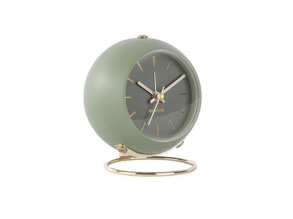 Karlsson Globe alarm clock in Moss Green, angled on its gold ring stand