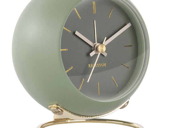 Close-up of the Moss Green Globe clock's dial and gold-tone stand