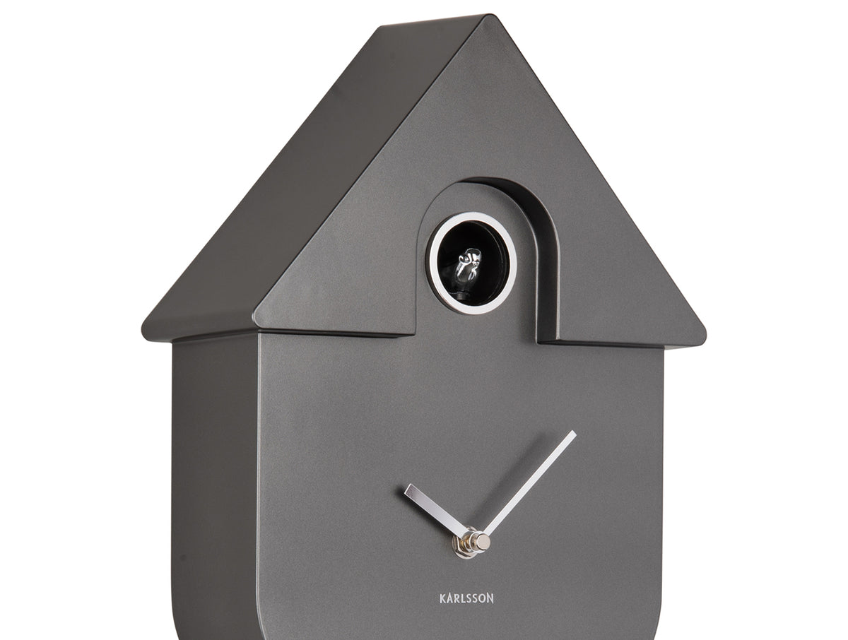 Karlsson Modern Cuckoo Clock in Metallic Dark Grey, angled close-up of the case and cuckoo window