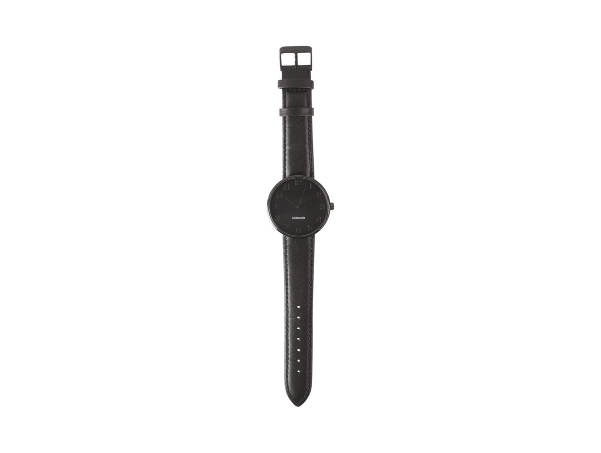 Karlsson Mr Black Steel watch photographed flat with the black leather strap extended
