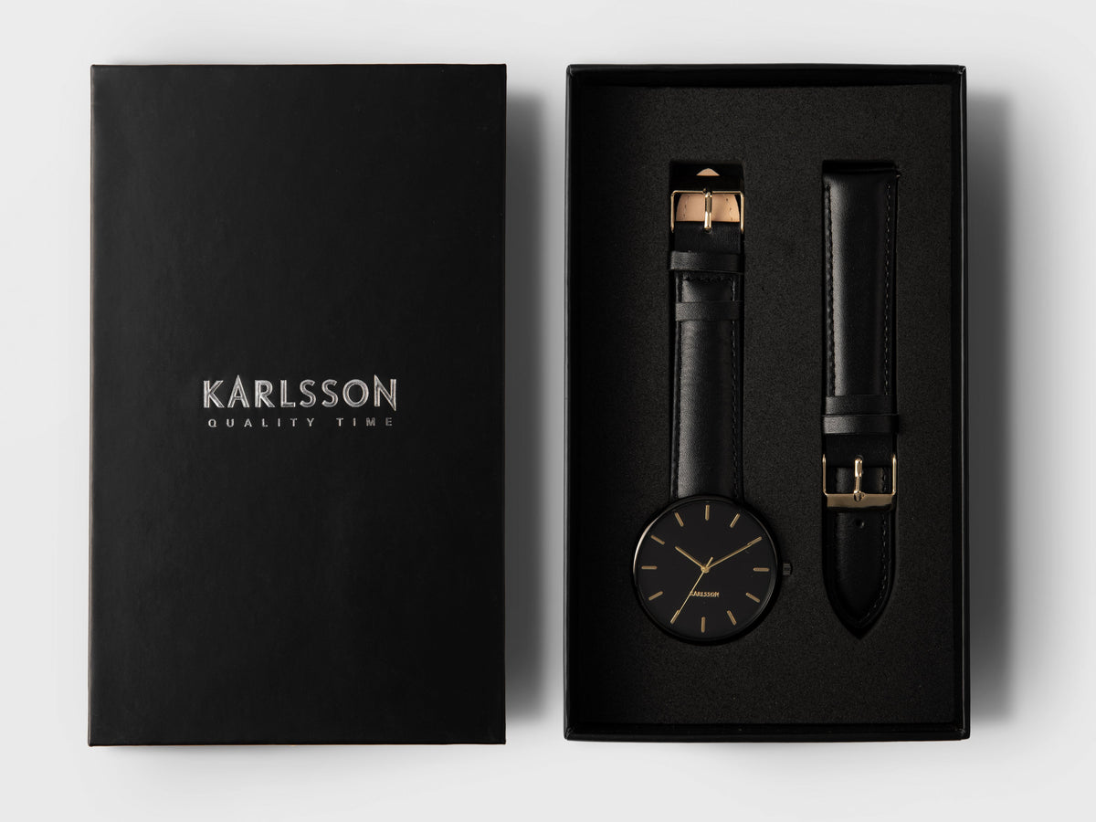 Karlsson Minimal watch in black in its presentation box with a spare black leather strap