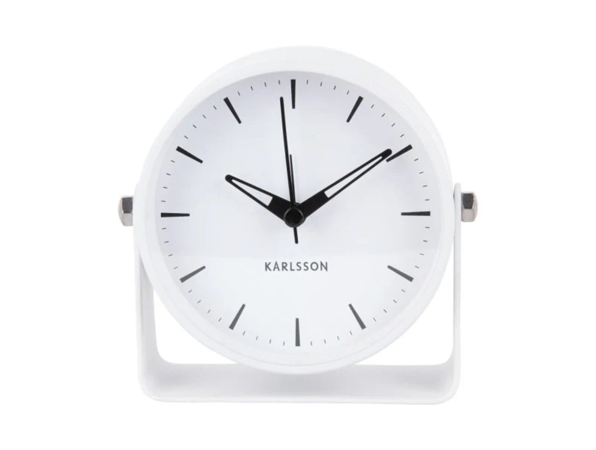 Front view of the white Karlsson Calm alarm clock showing its clean dial and curved stand