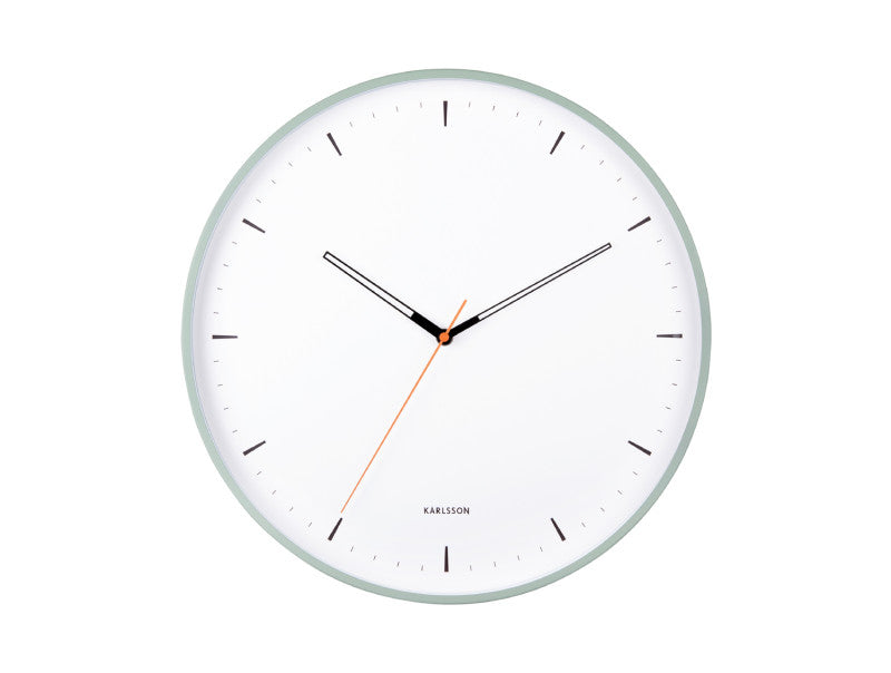 The clock in grayed jade shown straight on, white dial with black hands and an orange second hand