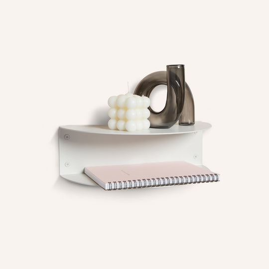 White FOLD Bedside Table Mini holding a candle and vases with a notebook on the lower shelf