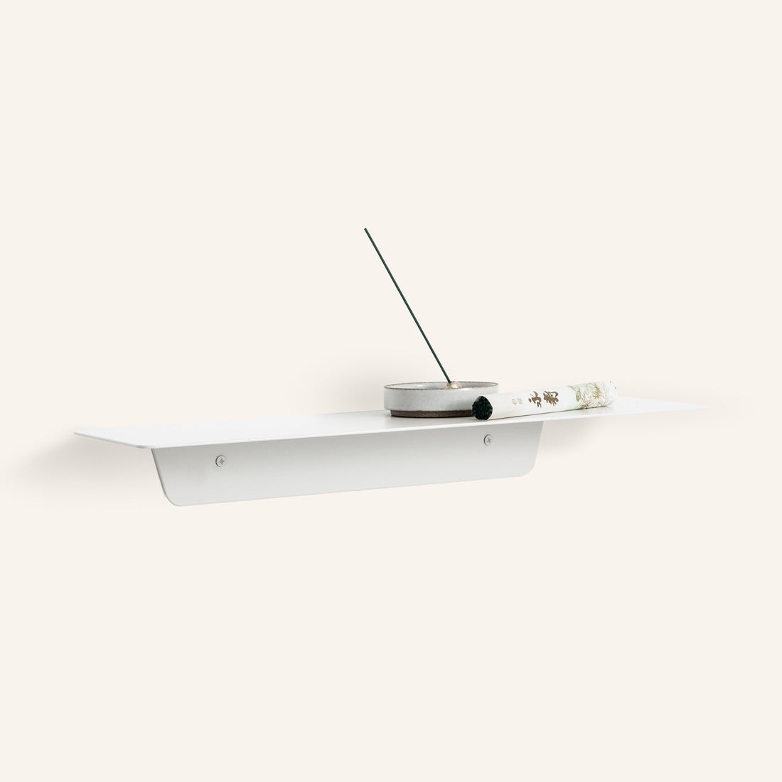 White FOLD Ledge with an incense stick, on a warm white background