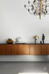 A minimalist wooden sideboard with a Flux Home Luca Table Lamp - Black / Brass.