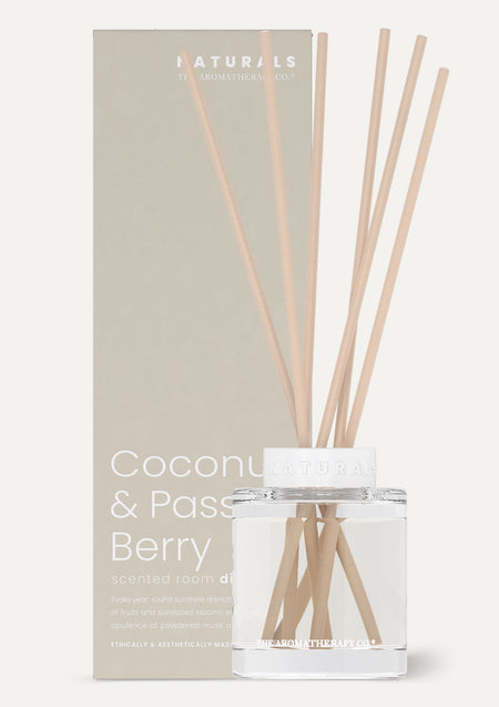 Coconut & Passion Berry reed diffuser beside its grey box on a pale background with a shadow