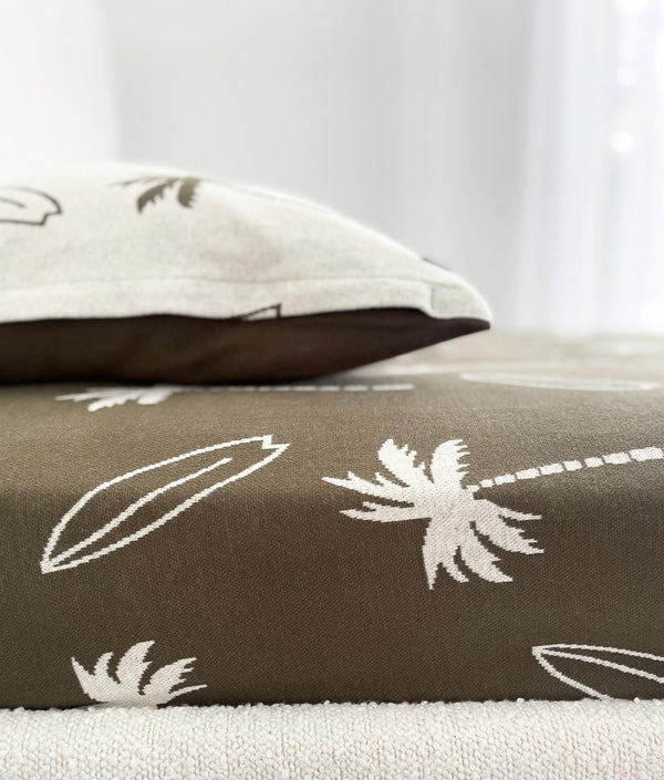 Surfing Palm kids cotton pillowcase with olive palm print and olive reverse on an olive Surfing Palm sheet