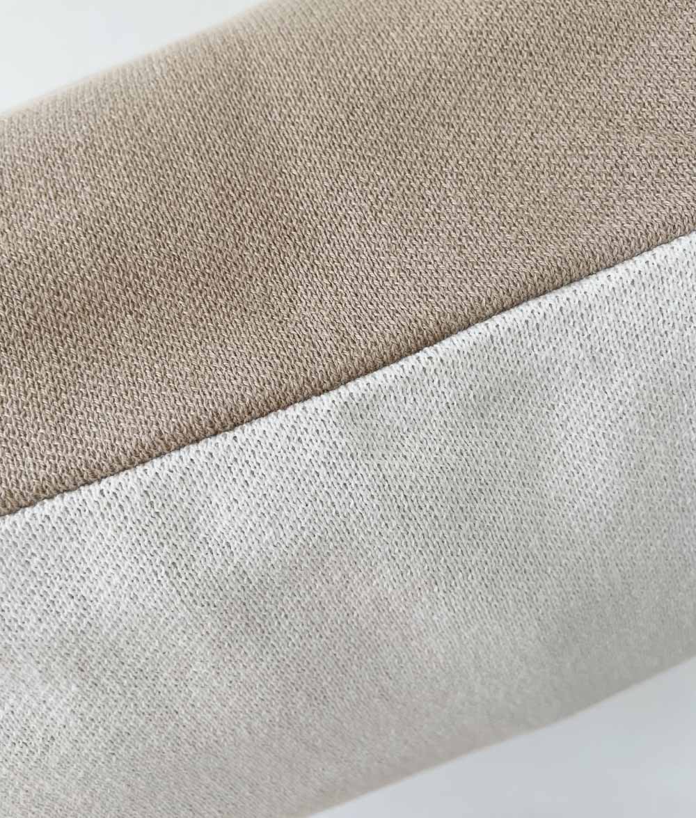 Close-up of soft jersey cotton knit in sand and natural, showing the fine stitch texture