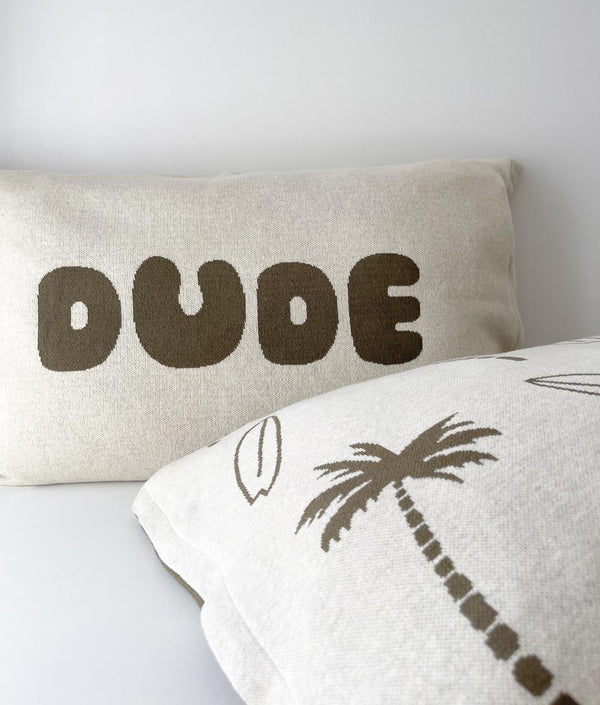Surfing Palm kids cotton pillowcase in front of a DUDE pillowcase with olive lettering