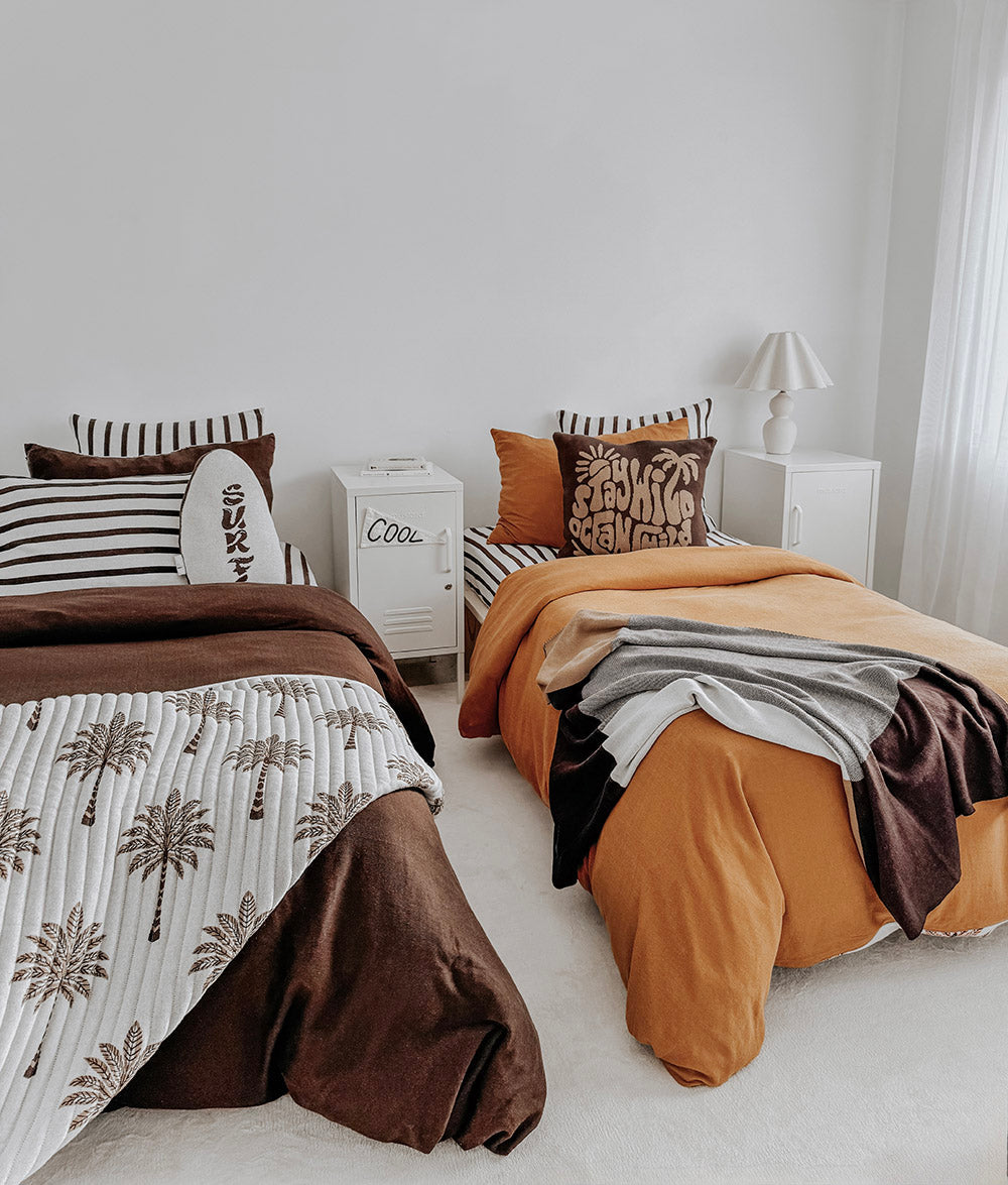 Shared kids room with two beds dressed in striped pillowcases, chocolate and tobacco bedding
