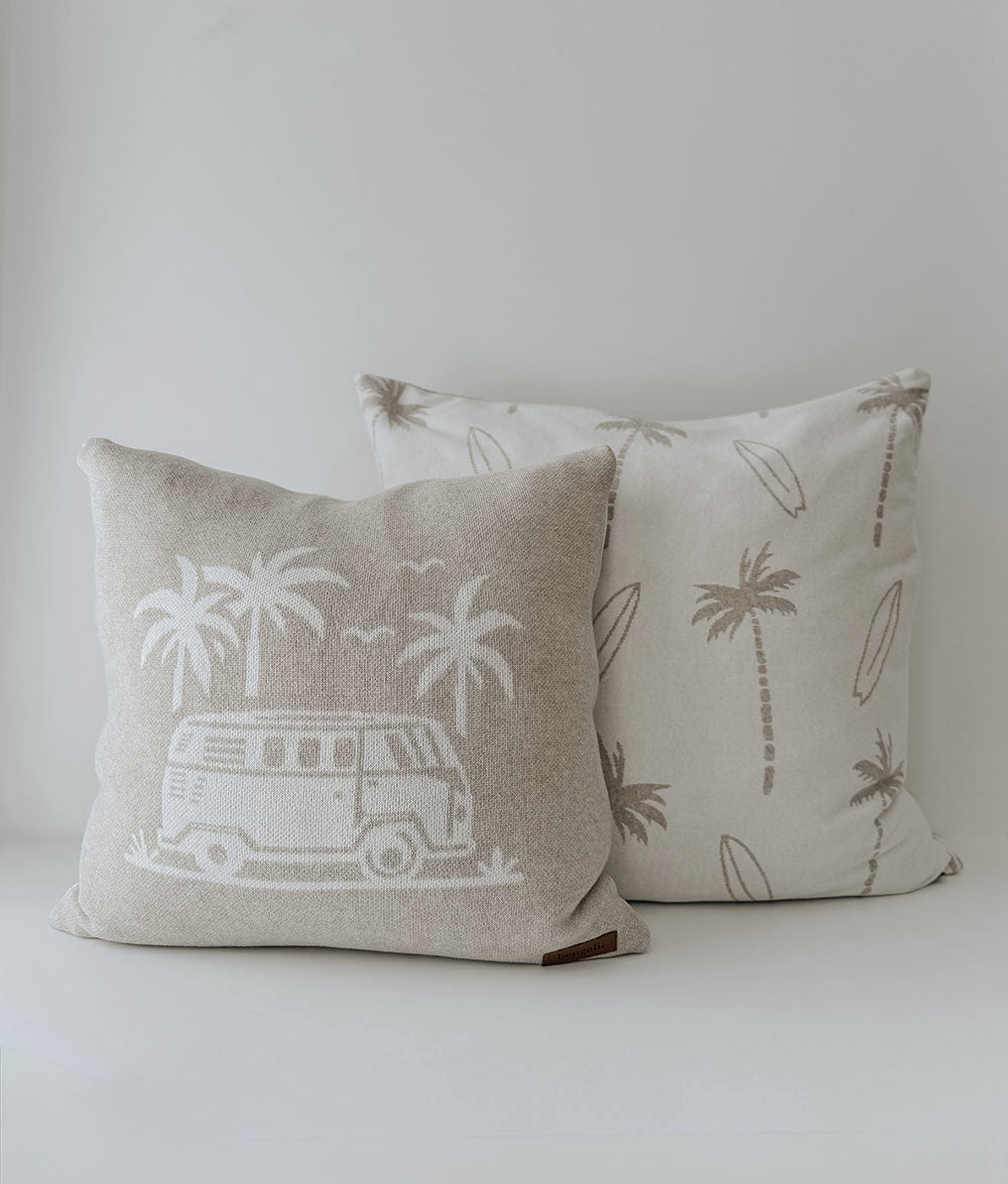 Dune palm and surfboard euro pillowcase behind a dune campervan cushion on white