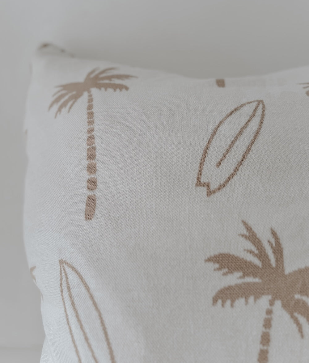 Close-up of the natural palm tree and surfboard print on the ivory euro pillowcase