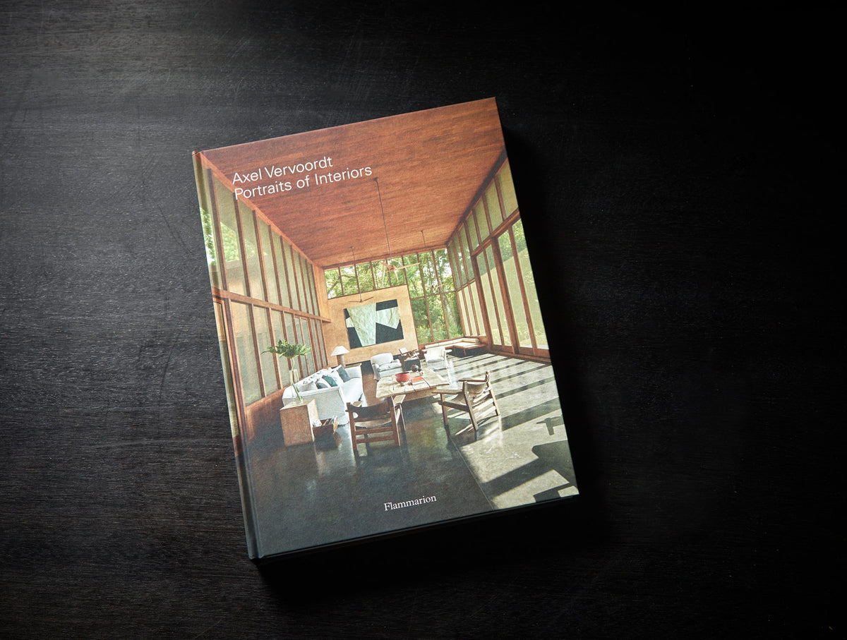 Axel Vervoordt Portraits of Interiors hardcover styled on a dark surface