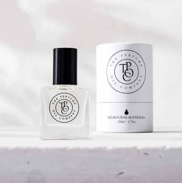 A bottle of MIDNIGHT perfume oil by The Perfume Oil Company with its box beside it