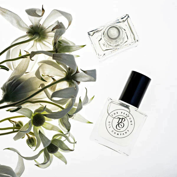 Roll-on perfume oil bottle with white lilies and the product box behind