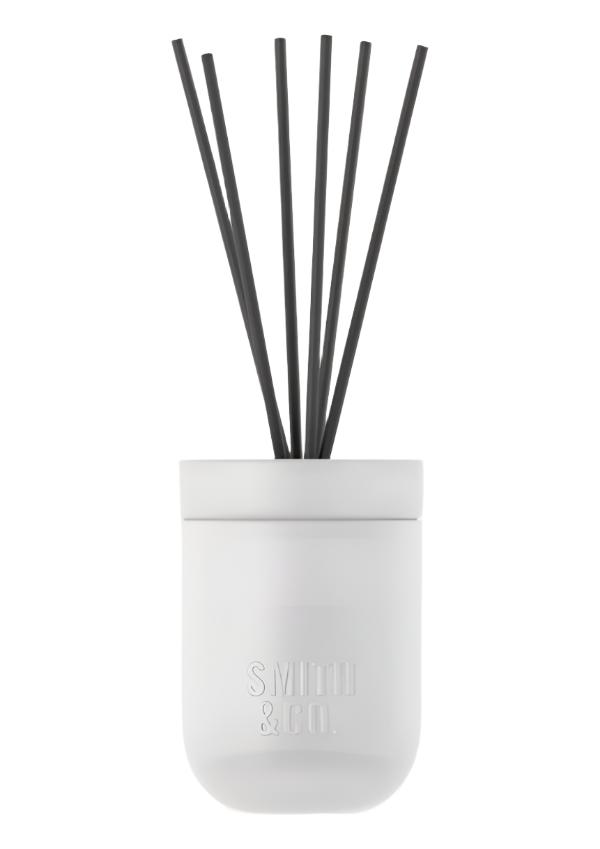Smith and Co white ceramic diffuser with black reeds on a plain white background