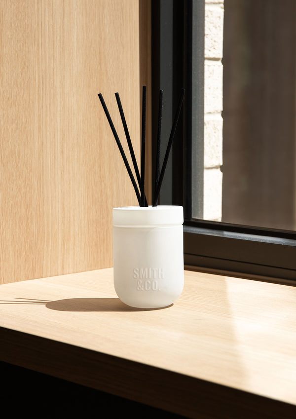 White Smith and Co diffuser on a sunlit pale timber window ledge