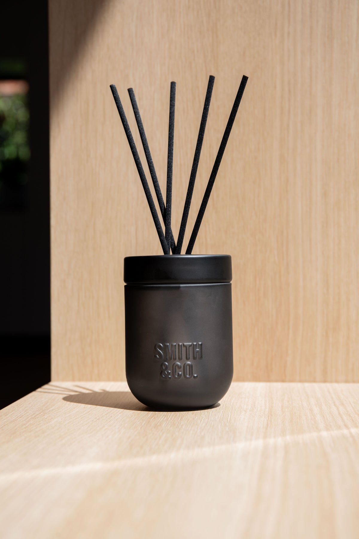Close view of the Smith & Co. diffuser on a timber shelf with a timber backdrop