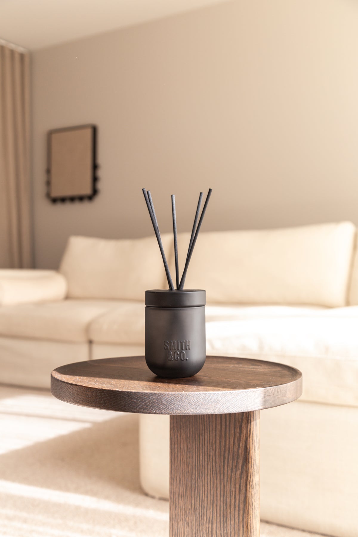 Smith & Co. diffuser on a side table in a soft cream living room