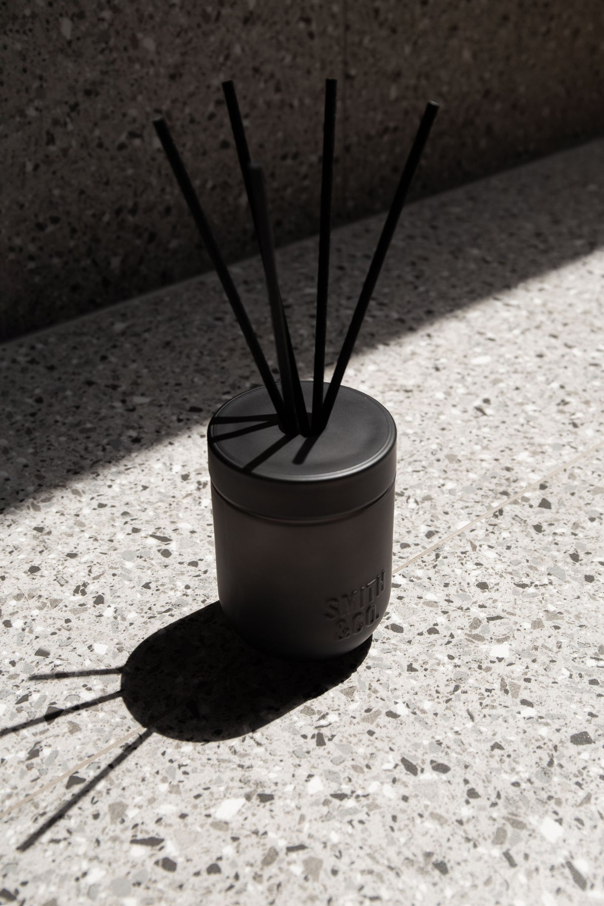 Smith & Co. diffuser on a terrazzo surface in hard afternoon sunlight