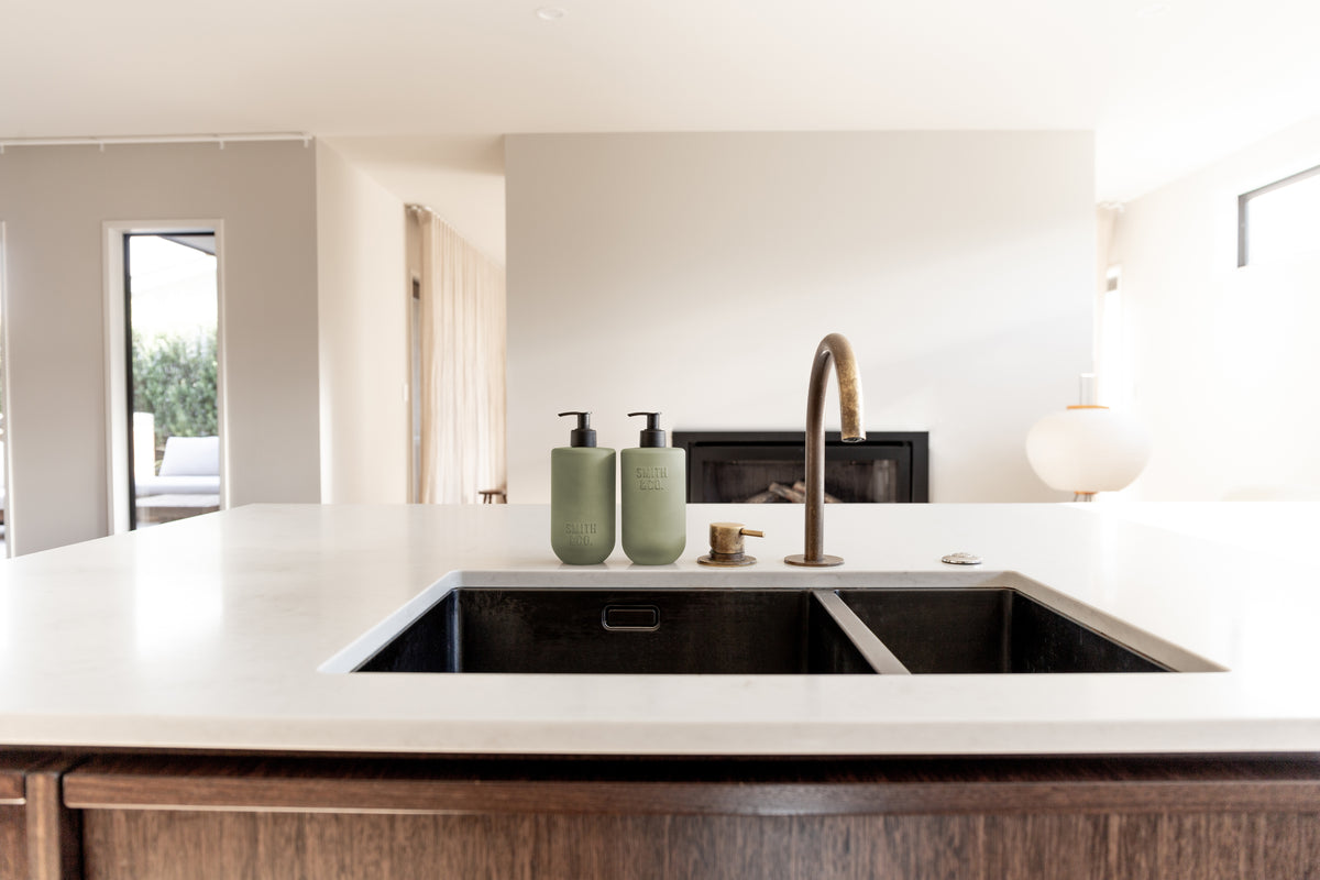Wide view of a kitchen sink run with Smith & Co. bottles