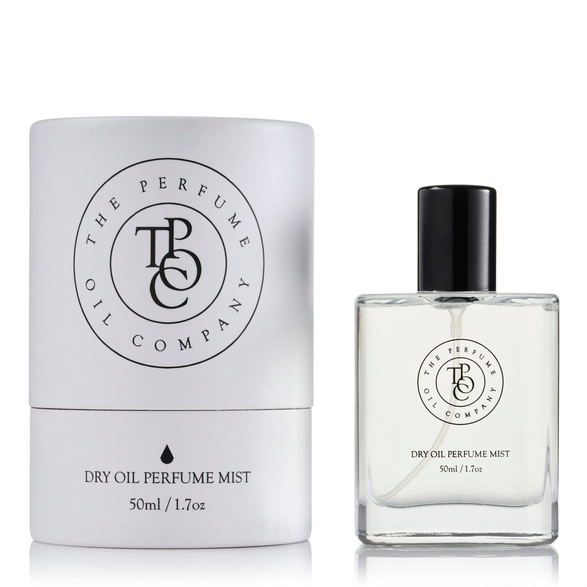 Dry oil perfume mist bottle standing beside its carton on a plain background