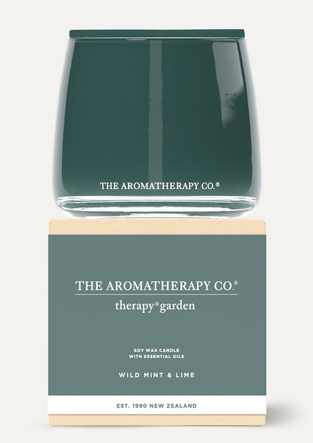 Therapy Garden Wild Mint & Lime candle stacked on its green box on a pale background