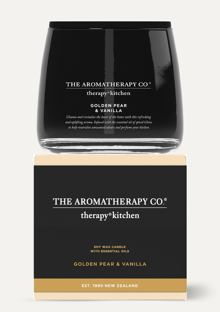Therapy Kitchen candle sitting on top of its black and cream gift box