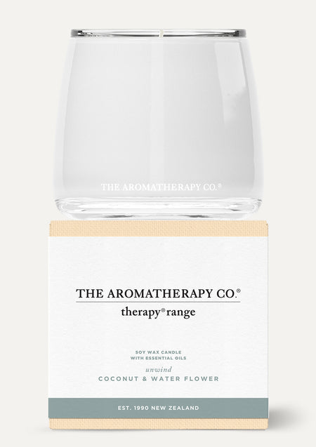 Therapy Coconut & Water Flower candle in white glass stacked on its white and sage box