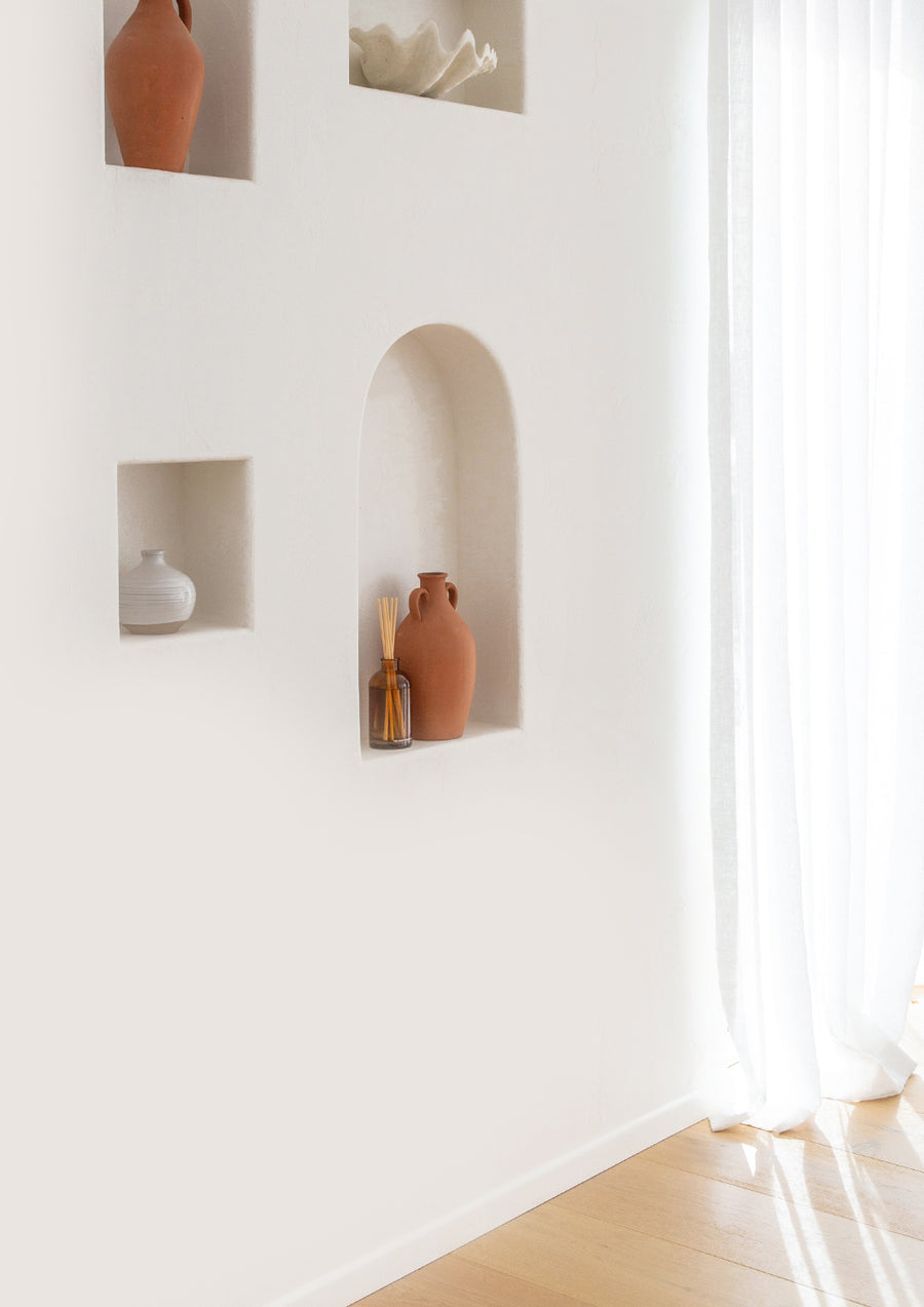 Bright room with a white wall niche and sheer curtains