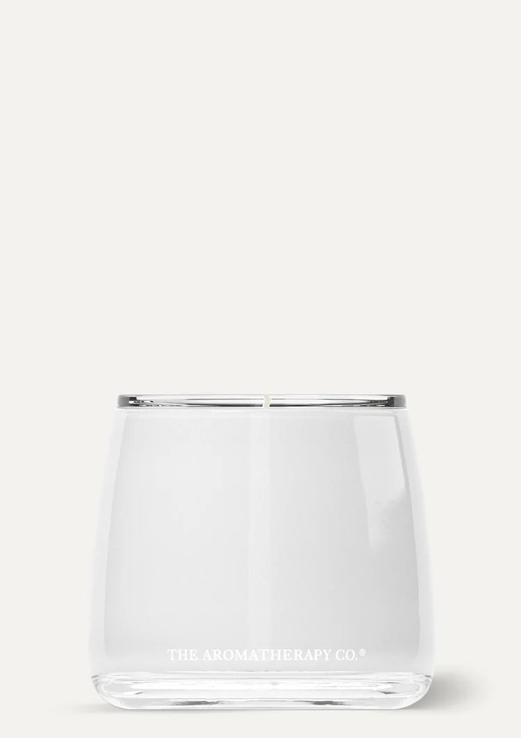 Therapy Embrace candle in clear curved glass on a pale grey background