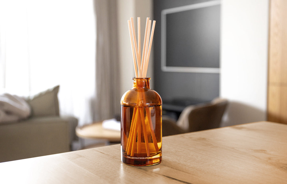 Therapy amber diffuser on a timber table in a living room